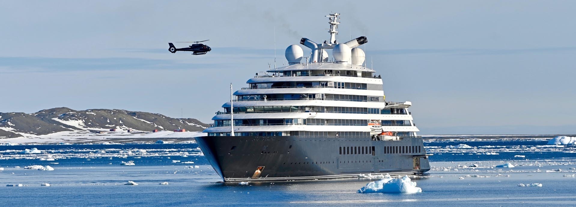 Ein Schiff umgeben von Schnee und Eis.