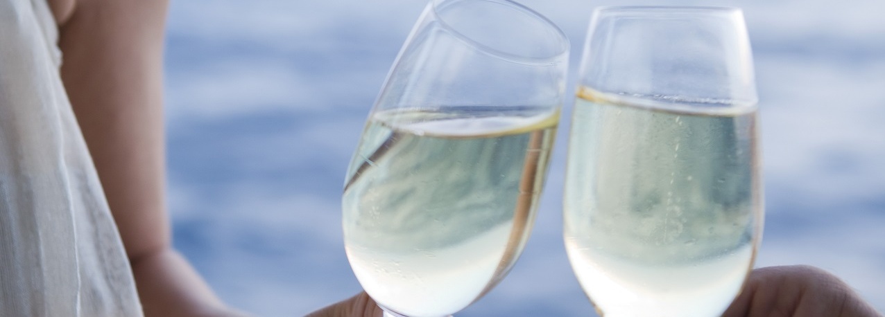 Ein Mann und eine Frau stoßen mit Sekt an.