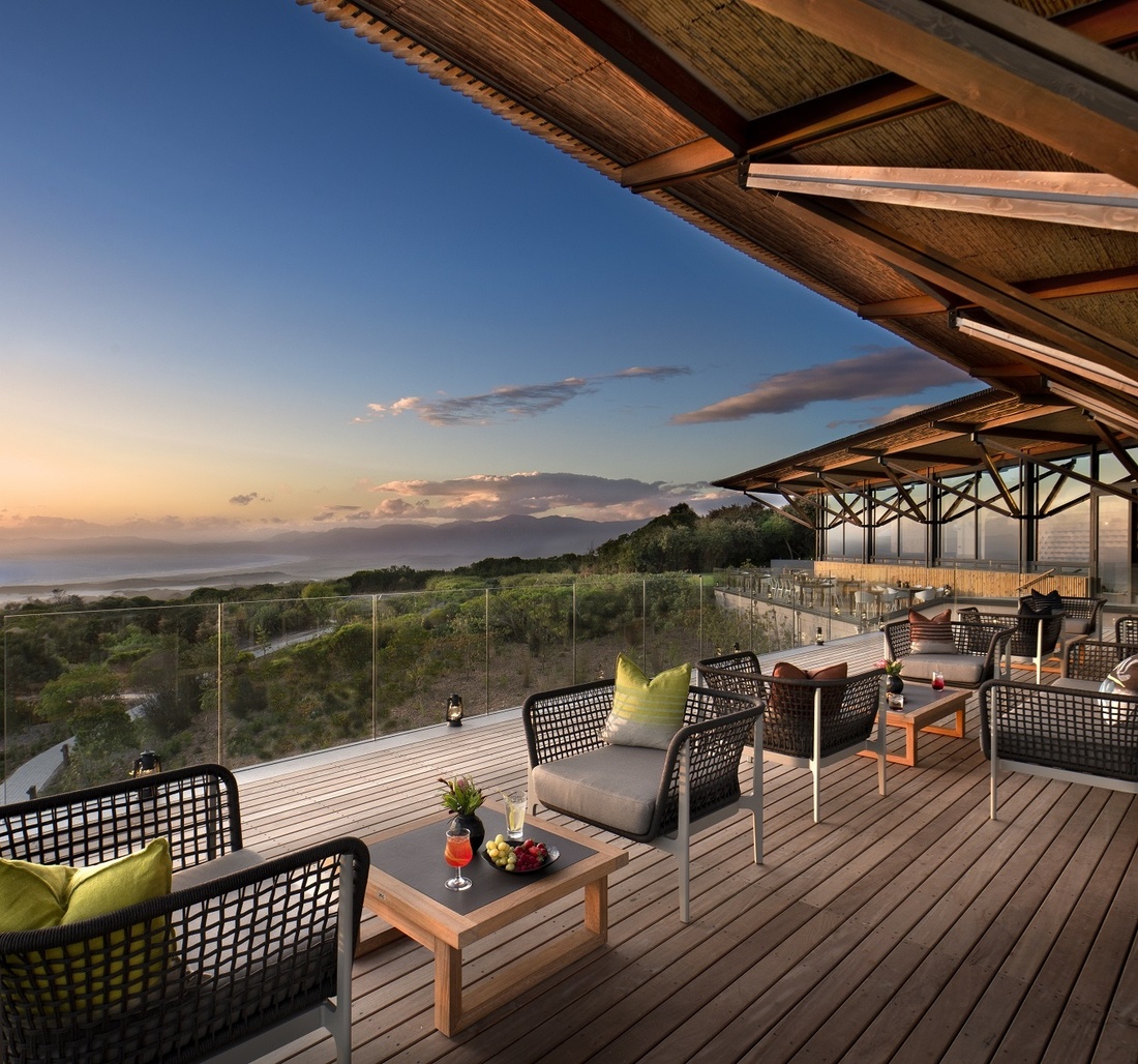 Auf einer Terrasse stehen Stühle und Tische.